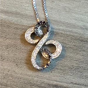 Jane Seymour black and white Diamond open heart pendant.
